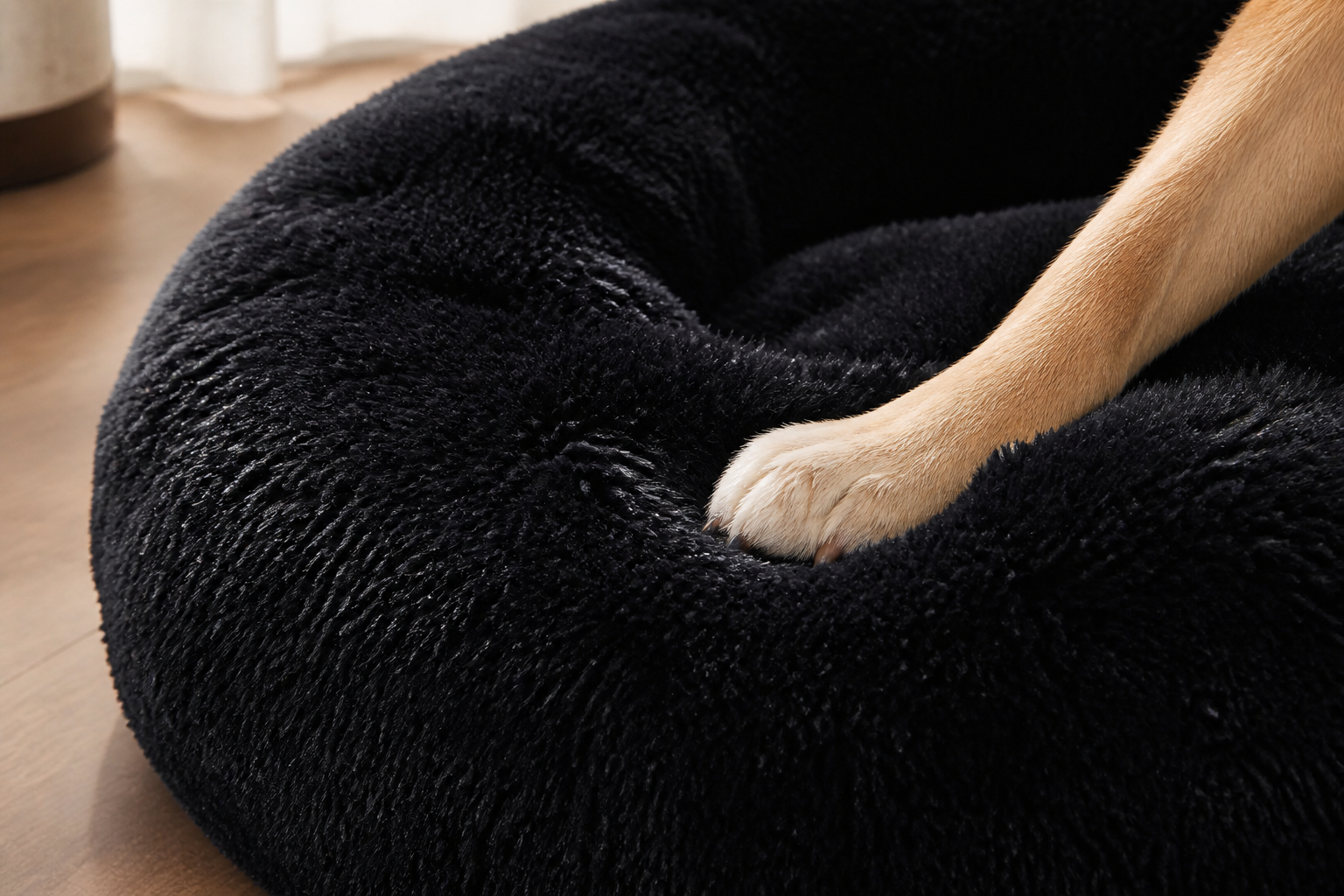 Black faux fur donut pet bed texture close-up